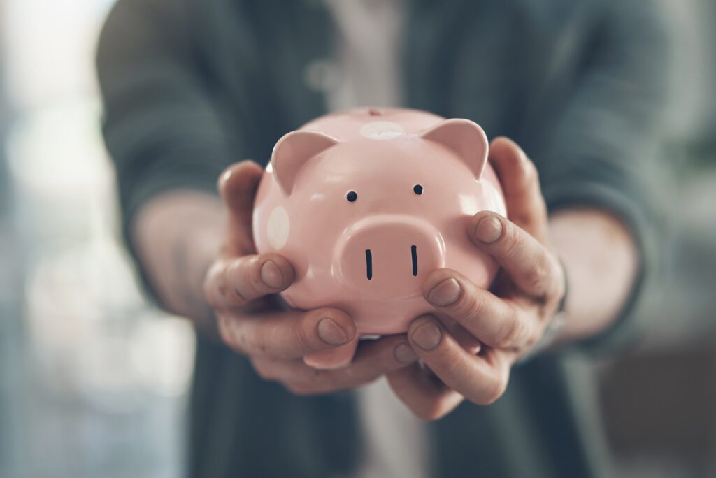 Your financial freedom is in your hands. Shot of an unrecognizable man holding a piggy bank.